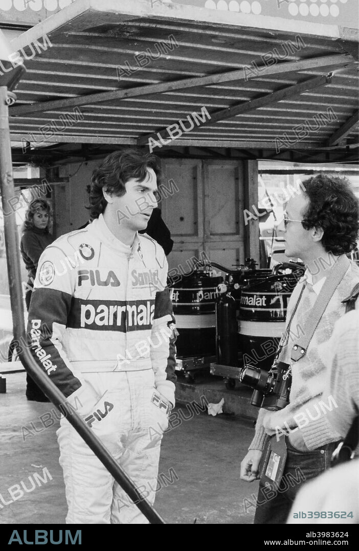 Nelson Piquet, Grand Prix of Europe, Brands Hatch, Kent, 1983. After making his Formula 1 debut in 1978, Brazilian driver Nelson Piquet enjoyed a long and successful career, the highlights being 23 Grand Prix victories and World Drivers' Championships in 1981 and 1983 with Brabham, and in 1987 driving for Williams. After retiring from Formula 1 he badly injured his foot in an accident in practice for the 1992 Indianapolis 500, prompting his retirement from motor racing. Piquet is pictured here in conversation with a photographer at the 1983 Grand Prix of Europe, one of three races he won on his way to winning the World Championship that season.