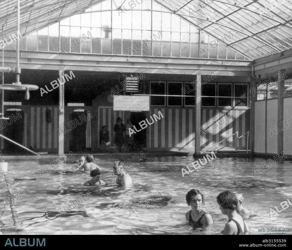Warm Springs, Georgia:  1928. Franklin Roosevelt exercises his polio damaged legs in the enclosed pool at Warm Springs, Georgia.