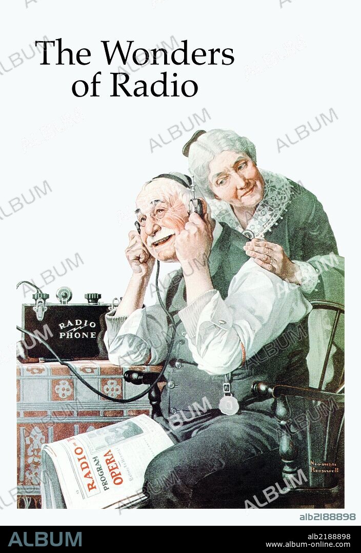 Old Man senior citizen listens to the wonders of radio on a headset while his wife leans on his back trying to hear.  He has Radio Newspaper on his knee.