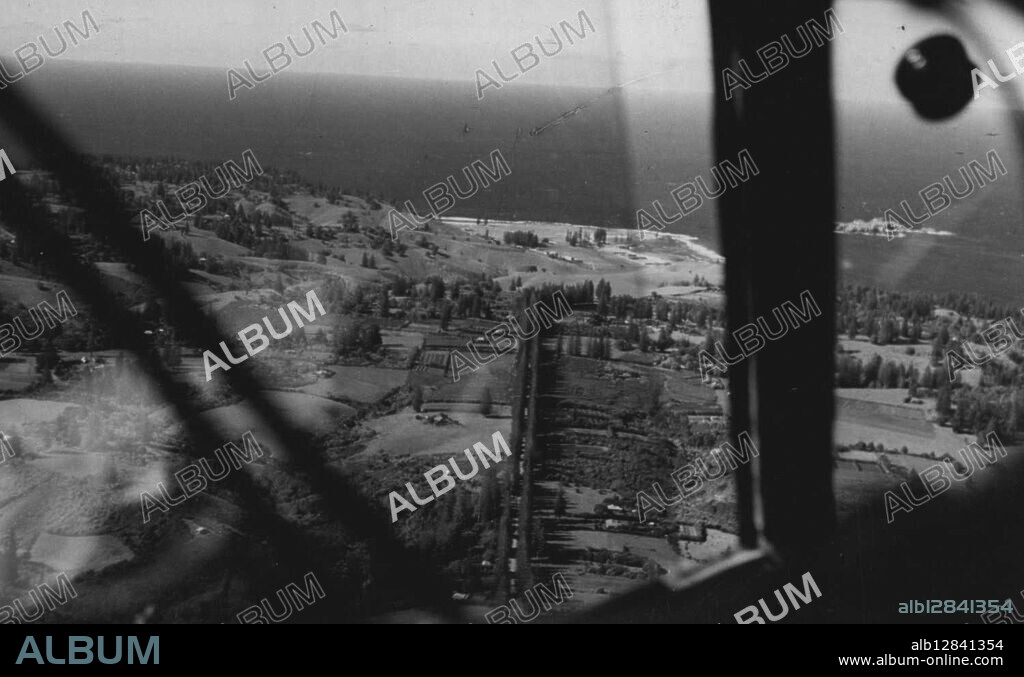 Norfolk Island -- First air photograph of Norfolk Island, taken when the American ***** flew low over it the Prime Minister, on his flight home, dropped a message the for the administrator, Sir Charles Rosentha, who in ***** rent a radio message to the airport. January 1, 1941.