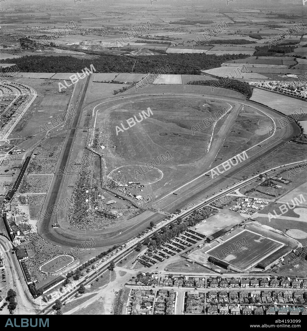 Doncaster Racecourse, Yorkshire, 1953. Aerial view of the racecourse with a meeting in progress. Belle Vue, home of Doncaster Rovers Football Club, is adjacent in the foreground.