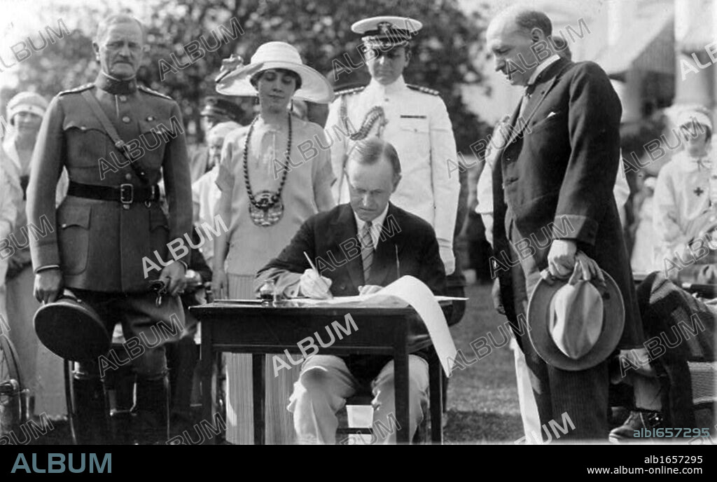 John Calvin Coolidge (1872-1933) 30th President of the USA 1923-1929 (Republican), signing Veterans' Bill and other bills on the White House Lawn, 1924. General of the Armies John Joseph Pershing (1860-1948) looks on. America.