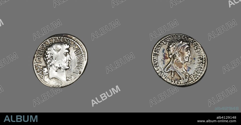 ANCIENT GREEK. Denarius (Coin) Portraying Mark Antony and Queen Cleopatra VII. Romano-Greek, mint moving with Antony. Date: 51 BC-30 BC. Dimensions: Diam. 1.9 cm; 3.36 g. Silver. Origin: Ancient Greece.