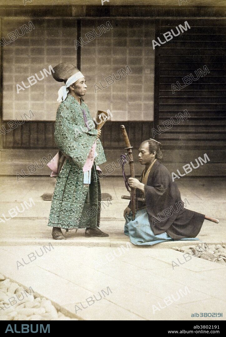 Entitled: "Samurai or retainer kneeling before government official or daimyo." The samurai, members of a powerful military caste in feudal Japan, began as provincial warriors before rising to power in the 12th century with the beginning of the country's first military dictatorship, known as the shogunate. As servants of the daimyos, or great lords, the samurai backed up the authority of the shogun and gave him power over the mikado (emperor). The samurai would dominate Japanese government and society until the Meiji Restoration of 1868 led to the abolition of the feudal system. Despite being deprived of their traditional privileges, many of the samurai would enter the elite ranks of politics and industry in modern Japan. The traditional samurai code of honor, discipline and morality known as bushido (the way of the warrior) was revived and made the basic code of conduct for much of Japanese society. The daimyo were the powerful feudal lords in pre-modern Japan who ruled most of the country from their vast, hereditary land holdings. Photograph published by Stillfried & Andersen, 1877. Albumen, hand-colored with watercolor.