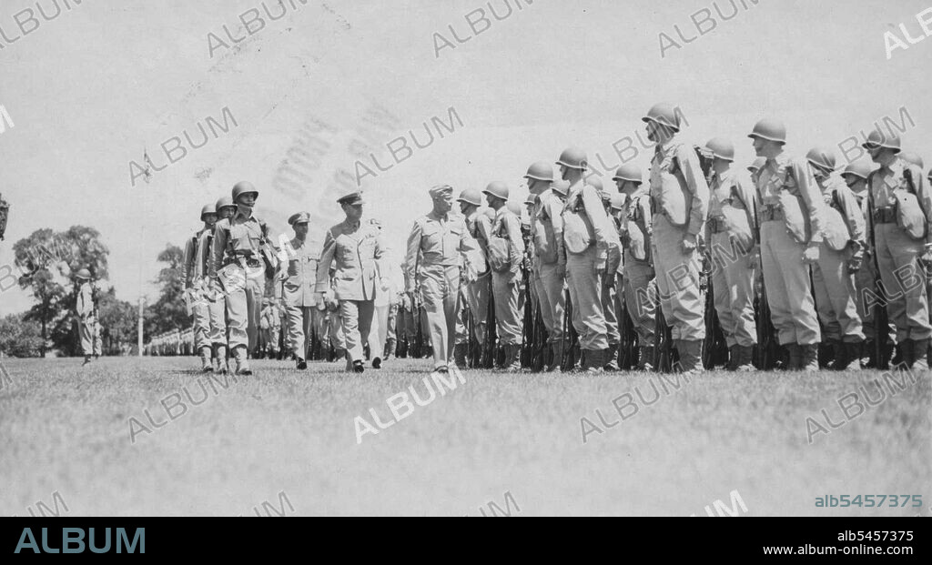 General Dwight D. Eisenhower At West Point -- General of the Army Dwight D. Eisenhower (center) inspects a unit of the 700-odd cadets who staged a review for the general on the sun-drenched parade ground at West Point yesterday. It was 30 years ago this month that the famed leader of the Allied armies in Europe departed the Point a second lieutenant. June 20, 1945. (Photo by ACME).