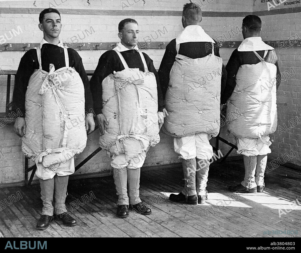 Recruits with their mattresses tied to them to serve as life preservers. United States Navy operations during World War I began on April 6, 1917, after the formal declaration of war on Germany. The American navy focused on countering enemy U-boats in the Atlantic Ocean and the Mediterranean Sea while convoying men and supplies to front lines in France and Italy. Because of United States' late entry into the war her capital ships never engaged the Germans and few decisive submarine actions occurred. Photo taken at Newport Naval Training Station, Rhode Island. Dated April, 1917.