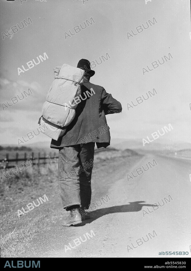 DOROTHEA LANGE. Migrant worker on California highway.