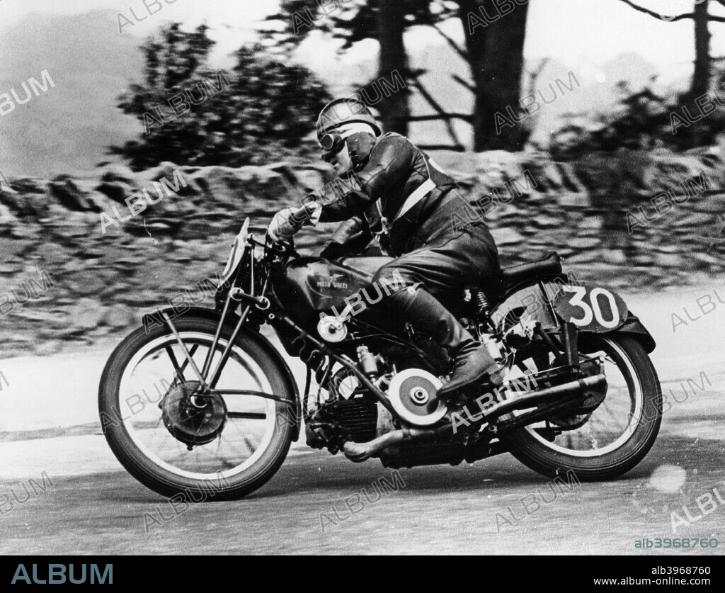 Stanley Woods on a 498cc Moto Guzzi bike, Isle of Man Senior TT, 1935. This was his most famous win. He was expected to stop at the end of the sixth lap for fuel, however he carried on racing and beat Jummy Guthrie by just four seconds to win the race.