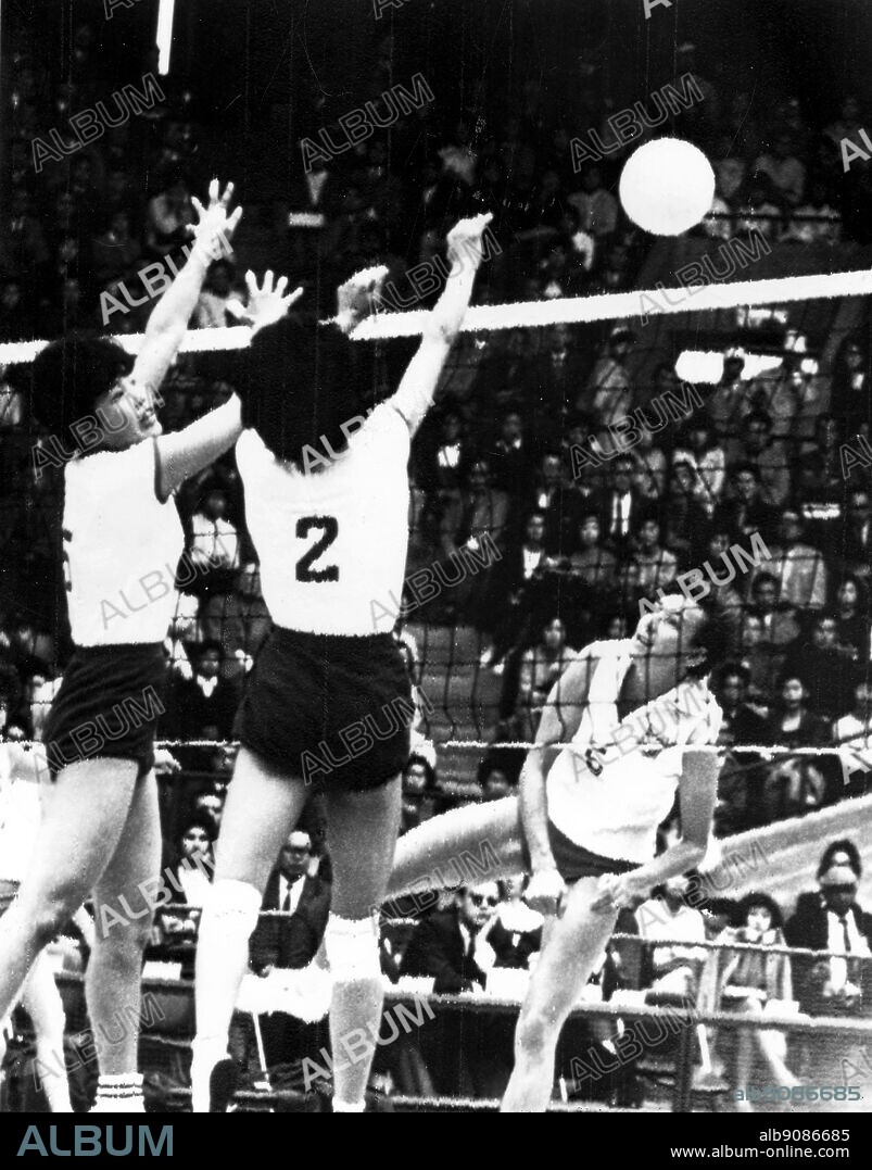 Japan, Tokyo Olympics, 1964: Women's volleyball between Japan and Poland. Japan's Miyamoto (#2) and Matsunura (#5) leap to block a shot from Poland's Kordaczeuk.