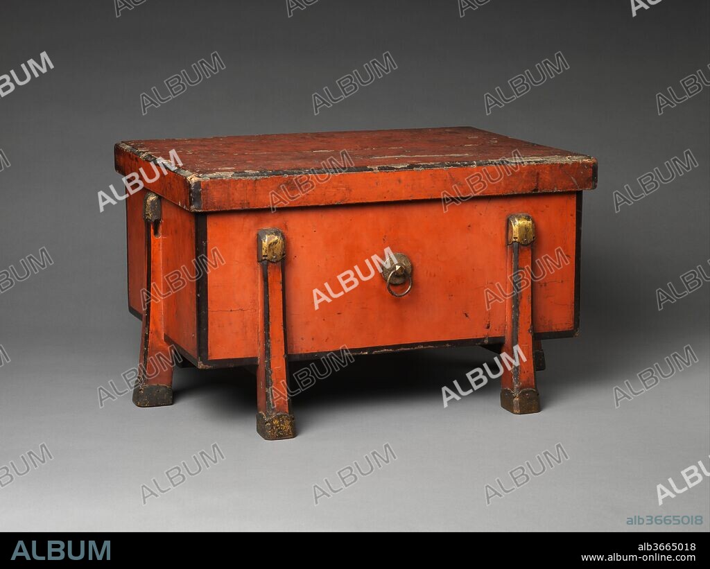 Storage Case (Karabitsu). Culture: Japan. Dimensions: H. 13 in. (33 cm); W. 15 3/4 in. (40 cm);  L. 22 1/8 in. (56.2 cm);. Date: 1422.
The karabitsu (literally, Chinese chest) is a rectangular lidded chest raised on four legs. The name implies a foreign origin for this elegant and functional form, used in Japan since the Nara period (645-794) to store precious objects, but no prototype has survived in China. Although its origin is obscure, the form is well suited to Japanese usage, highly functional for storage in a humid climate and attractive for display in the sparely furnished interiors of traditional architecture. Early extant examples from the twelfth century are black with mother-of-pearl inlay, although a similar undecorated red lacquer chest is recorded to have been made in 1040 for the sacred mirror, one of the three imperial regalia. In its earliest form, the box was square with taller legs; the proportions of this later chest, with shorter and wider legs, give it a more solid appearance. Despite the damage to the lacquer on its lid, this richly colored chest is a prime example of Muromachi-period Negoro lacquerwork.