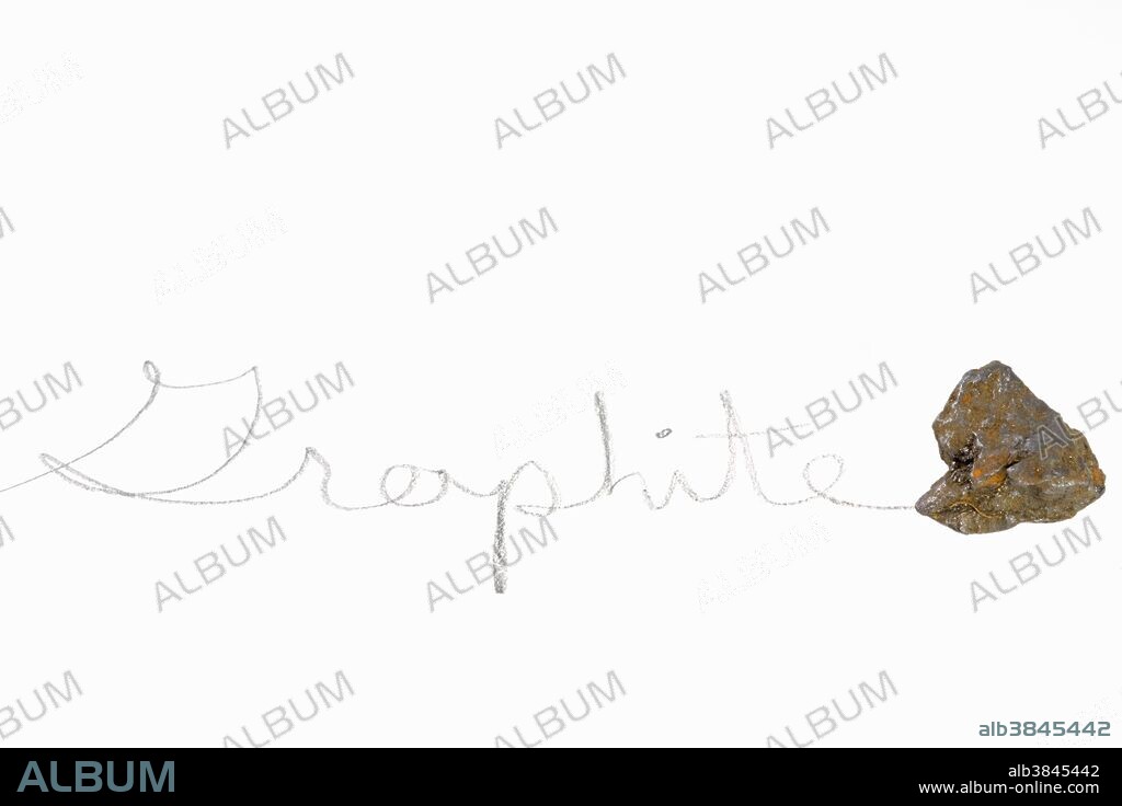 The word "graphite" written with a piece of graphite, a soft carbon mineral.