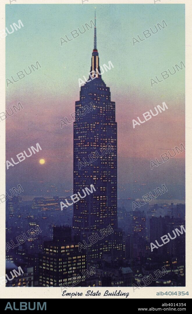 Empire State Building, New York City, New York, USA, 1956. Vintage postcard showing the Empire State Building at dusk. The surrounding buildings and the city skyline is also visible. The Art Deco Empire State Building, designed by Shreve, Lamb, and Harmon, was the world's tallest building when it opened in 1931. Since the destruction of the World Trade Centre in 2001, it is once again the tallest building in New York.