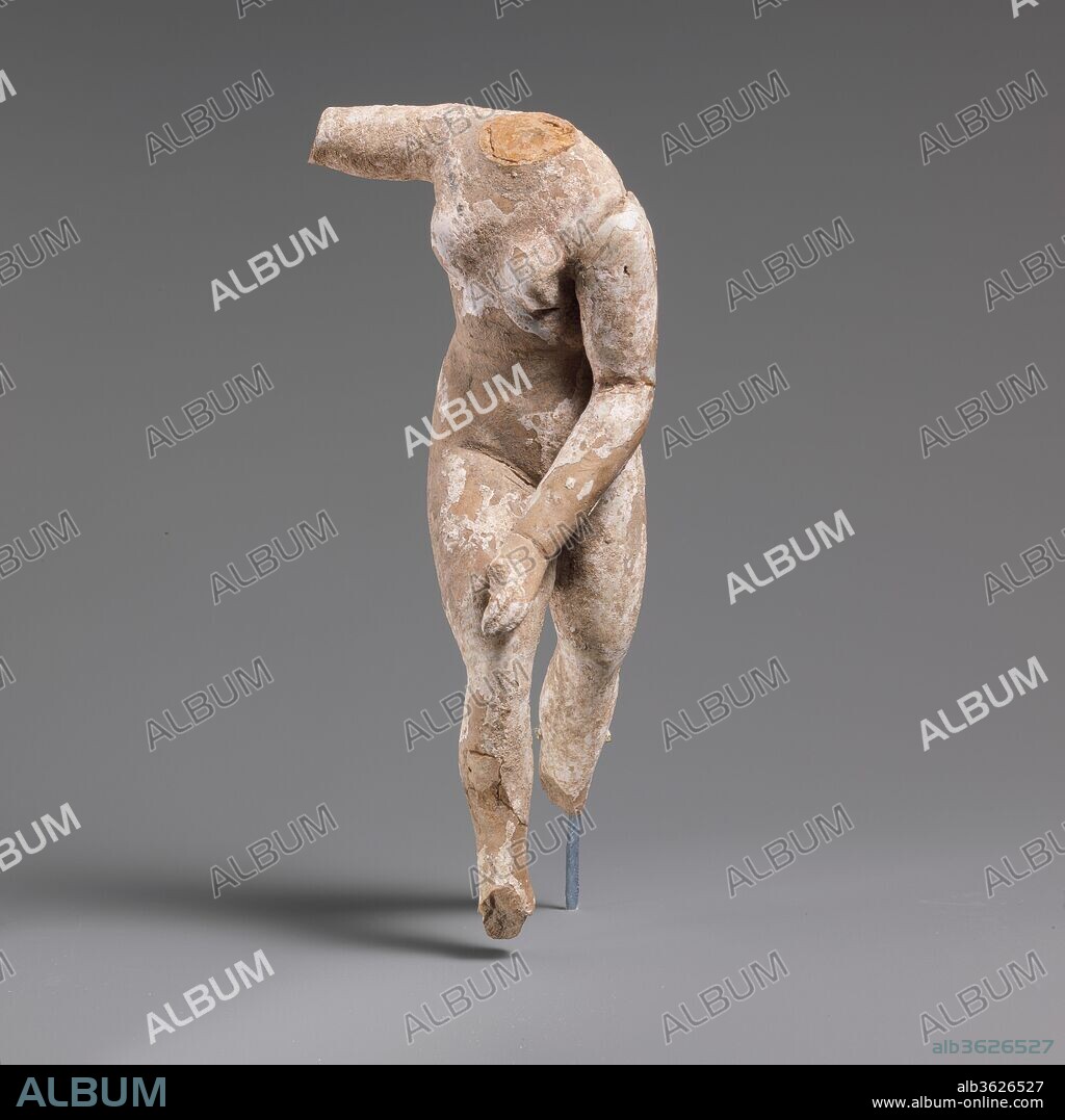 Terracotta nude female statuette, perhaps Aphrodite. Culture: Greek, South Italian, Tarentine. Dimensions: H. 8 3/8 in. (21.3 cm). Date: 3rd century B.C..
Nude, wearing fillet, hair dressed high at back, right hand raised.