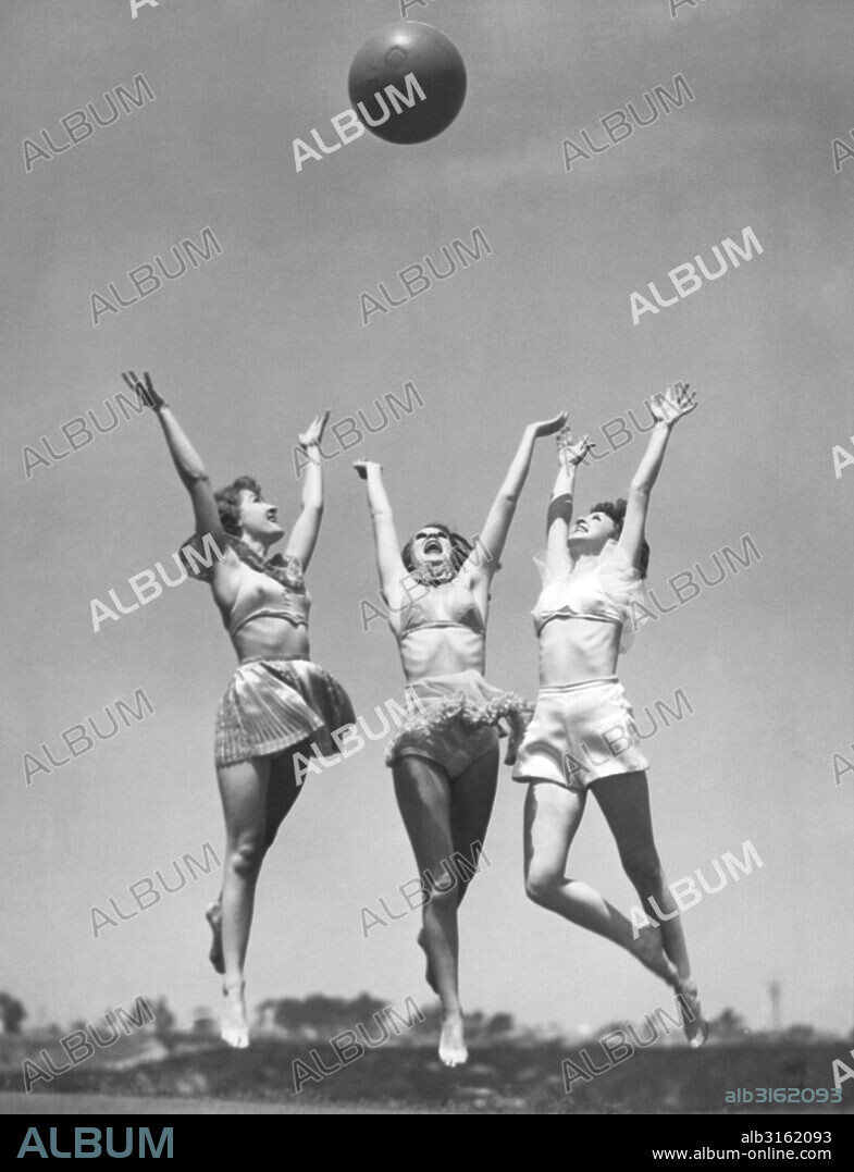 San Diego, California: August 29, 1935. Beauty contest winners at the Miss America show at the California Pacific International Exposition take time from their dancing to exercise with a medicine ball.  L-R: Wilamet Matson, Miss England; Joy Williams, Miss Scotland and Pearl Alten, Miss Ireland.