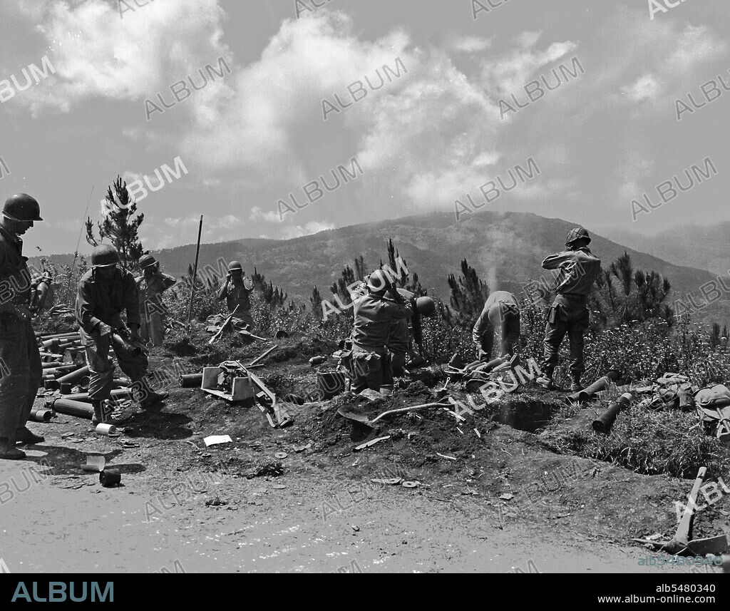 Mortar crews from the 37th Infantry Division fire on enemy positions on the road to Baguio, Luzon, Philippine Islands, April 22, 1945.