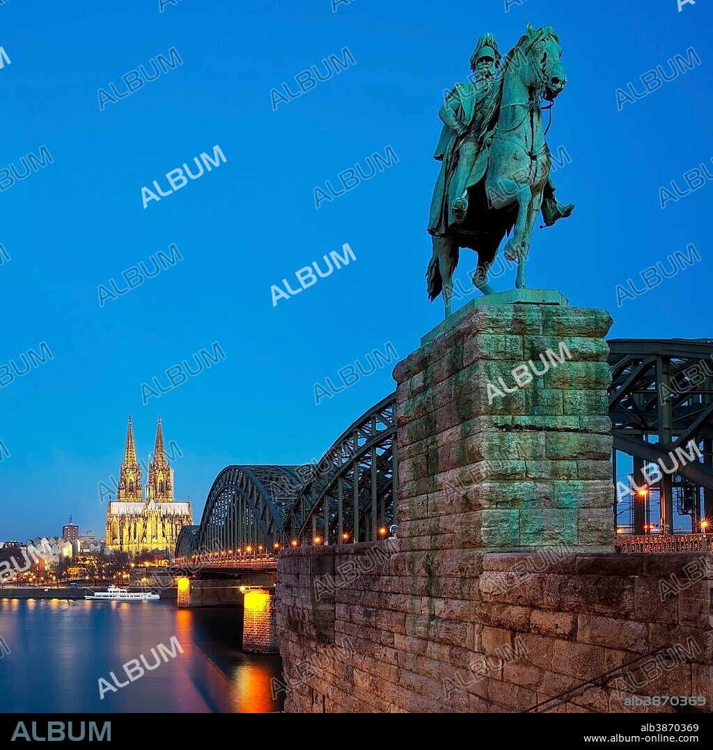 Equestrian statue of Emperor Wilhelm I. with Cologne Cathedral and Hohenzollern Bridge in the blue hour, Cologne, Rhineland, North Rhine-Westphalia, Germany, Europe.