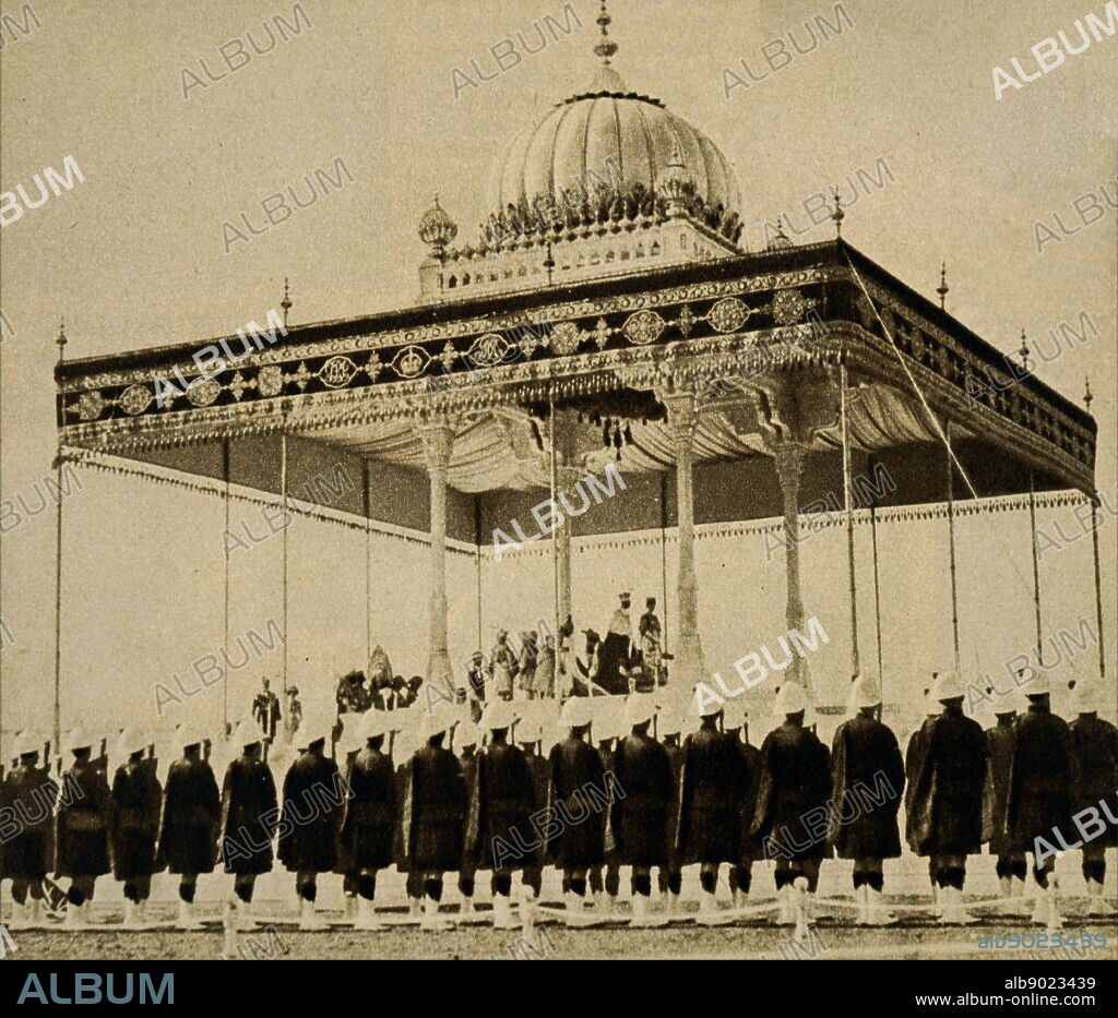 Photograph taken during the Delhi Durbar of 1911, with King George V and Queen Mary seated upon the dais. The Delhi Durbar, meaning the Court of Delhi, was an imperial style mass assembly organised by the British at Coronation Park, Delhi, India, to mark the succession of an Emperor or Empress of India. King George V (1865-1936) King of the United Kingdom and the British Dominions, and Emperor of India. Queen Mary of Teck (1867-1953) Queen of the United Kingdom and the British Dominions and Empress of India as the wife of King-Emperor George V. Dated 20th century.