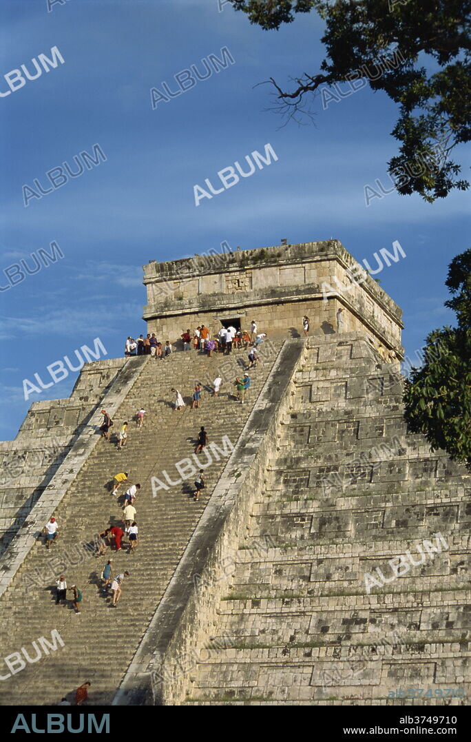 Tourists climbing El Castillo, pyramid dedicated to the god Kukulcan, Chichen Itza, UNESCO World Heritage Site, Yucatan, Mexico, North America.