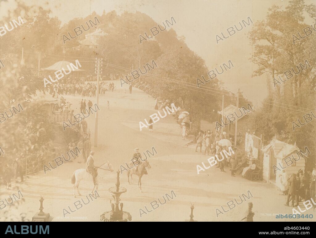 India, View of Darjeeling looking towards the bandstand and 'chowrasta', the equivalent of a town square on the ridge of the town itself. The scene shows a busy time of day, with Europeans and Indians standing, seated and on horseback.Printed caption: No. 10. THE CHOWRASTATH. PAAR. DARJEELINGOriginal manuscript caption: Darjeeling, circa 1900. 2003/071/1/1/3/21.