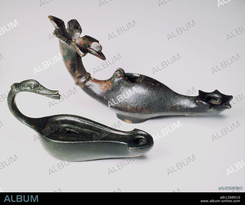 Lucerna (antigua lámpara romana) de bronce. Asa rematada con cabeza de ánade. S. II. Altura: 7,9 m. Longitud: 16,3 cm. Anchura: 7 cm.
