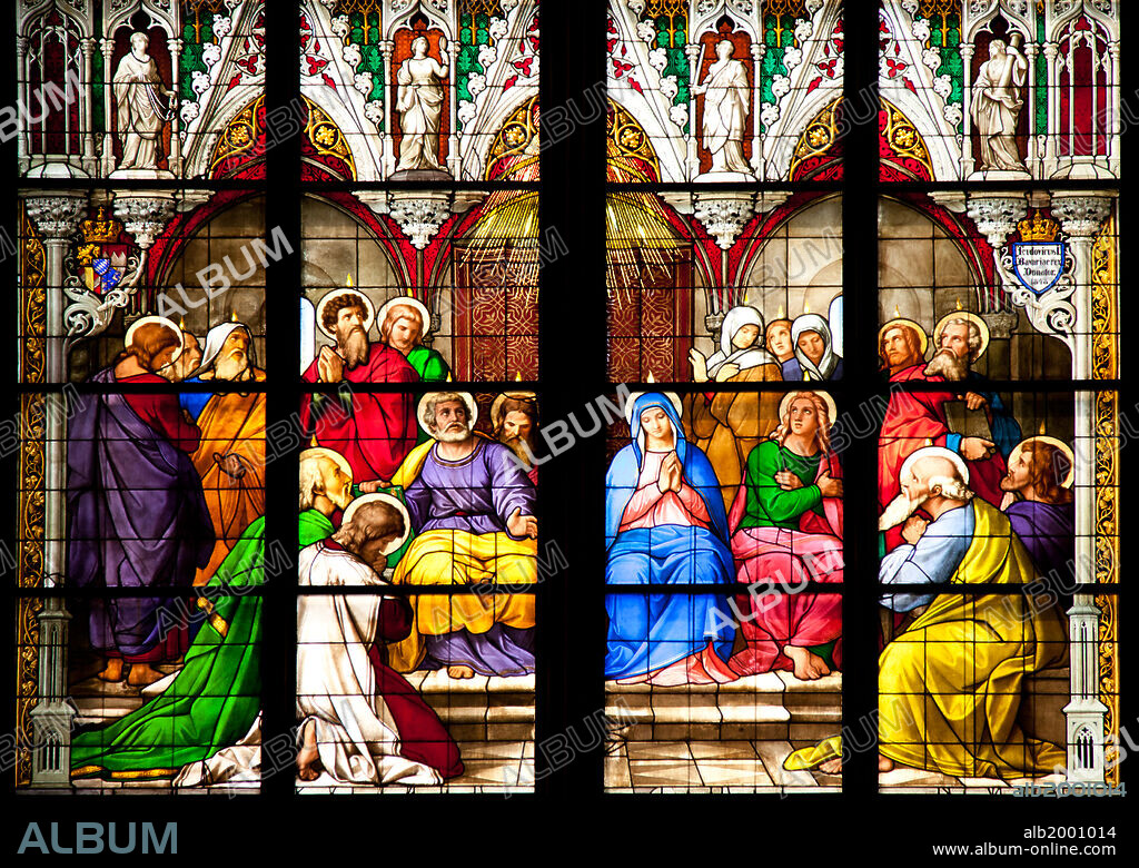 Germany, Cologne, Cologne Cathedral, South Aisle, Stained Glass Window, The Pentecost Window. Cologne Cathedral was built was built to house the relics of the Three Magi, under the direction of Archbishop Conrad von Hochstaden. Construction of the present Gothic church began in August 15th, 1248 and completed in 1880. In 1996, the cathedral was added to the UNESCO world heritage list of culturally important sites. The Window depicts the descent of the Holy Spirit on the day of Pentecost. The standing figures in the architectural frames of the main scene embody the four cardinal virtues: fortitude, justice, wisdom, and temperance.