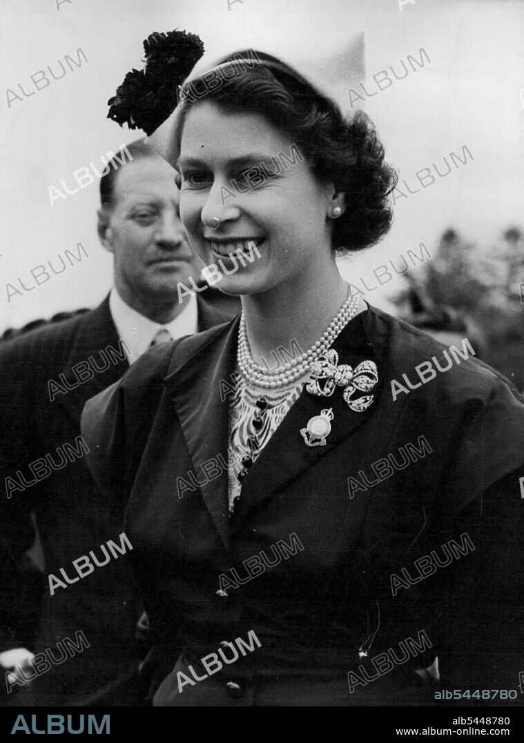 The Queen At Royal Show -- This happy picture of Queen Elizabeth was made during her 6½-hour visit to the Royal show at Newton Abbot, Devon, yesterday July 2. Crowds lined the street to welcome the first British monarch to visit the town since Charles I was there in 1625. Waiting the great the Queen at the Royal Pavilion was the minister of Agriculture, Sir Thomas Dugdale. The Queen later presented the Royal Agricultural society's long-service medal to 14 farm workers whose length of service on one farm ranged from 66 years to 40 years. July 3, 1952. (Photo by Associated Press Photo).