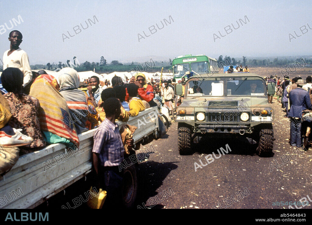 1994  Zaire - A US military High-Mobility Multipurpose Wheeled Vehicle (HMMWV) enters the Kibumba refugee camp in Goma Zaire Operation Support Hope.