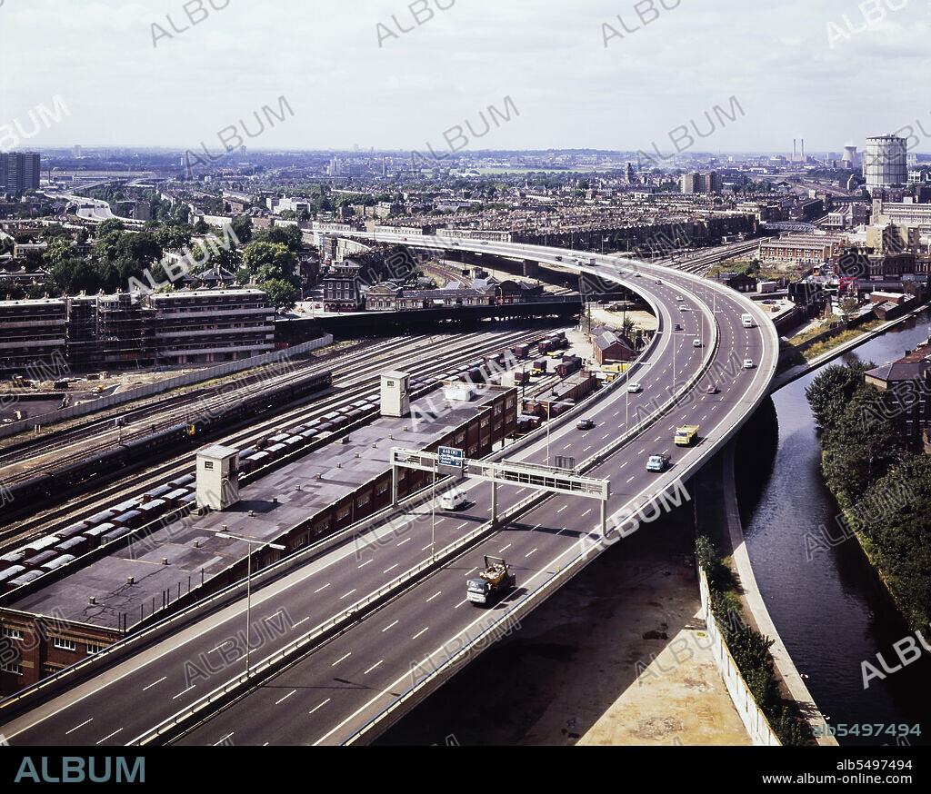 JOHN LAING PLC. Westway Flyover, A40, Paddington, City of Westminster, London, 01/09/1971. An elevated view looking west along the route of the Westway Flyover, showing it overhanging the Grand Union Canal and curving to cross the railway near Westbourne Park Station. Work on site for the Western Avenue Extension began on 1st September 1966, and the Westway as it became known was officially opened on 28th July 1970. The elevated highway connecting the A40 at White City to Marylebone Road in Paddington, at around 2 ½ miles, was the longest in Europe. This photograph was taken at grid reference TQ2491181834.