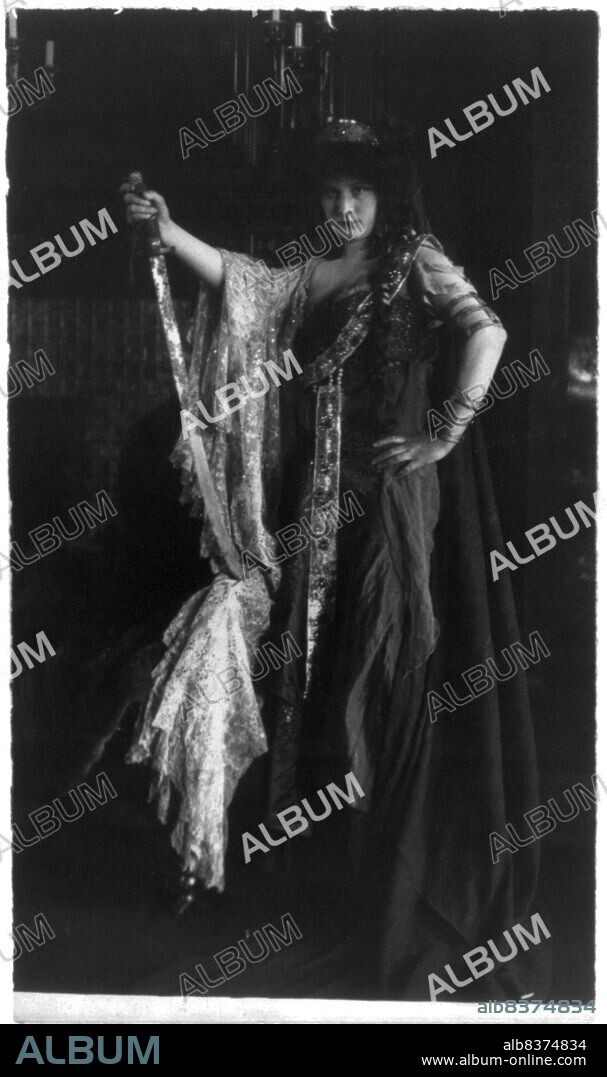 FRANCES BENJAMIN JOHNSTON. Marguerite Cassini, 1882. Daughter of Russian Ambassador to U.S., full-length portrait, standing in jewelled gown, holding sword, facing left. ['Countess' Marguerite Cassini was the daughter of Arthur Pavlovich Nicolas Cassini, Count de Cassini.