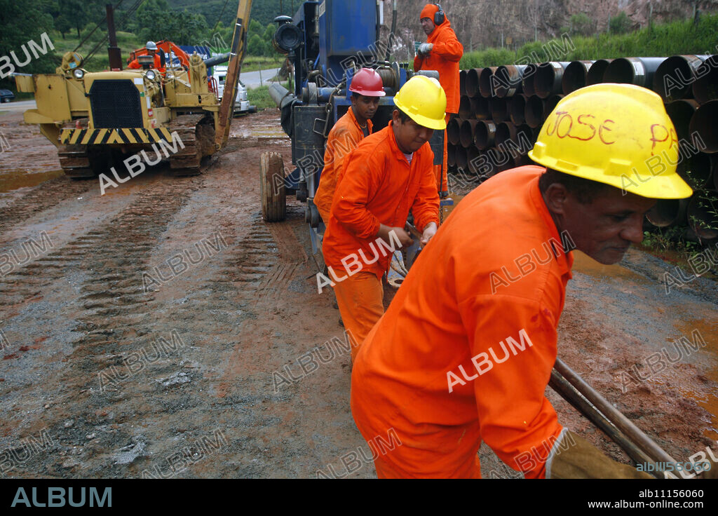 Workers putting pipes for natural gas near Congonhas, Minas Gerais, Brazil, South America.
