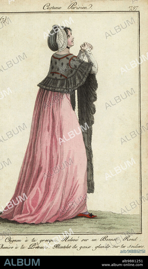 She wears a Greek-style bun raised in a round bonnet, a priestess-style dress, gauze mantle and slippers with tassles. Chinon a la grecque. releve sur un bonnet rond. Chemise a la Praitresse. Mantelet du gaze, glands sure les souliers. Handcoloured copperplate engraving from Pierre de la Mesangeres Journal des Modes et Dames, Paris, 1797. The illustrations in volume 1 were by Carle Vernet, Claude Louis Desrais and Philibert Louis Debucourt.