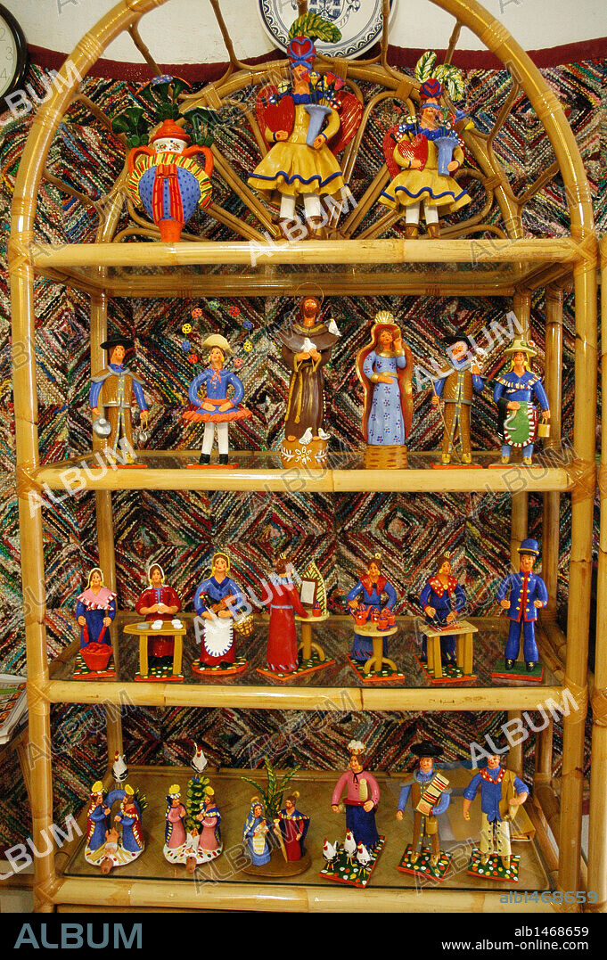 BONECOS. Figuras grotescas realizadas en barro que representan a sacerdotes, campesinos, etc. y que tienen un cierto aire místico. BONECOS pintados de vivos colores en un colocados en un expositor. Estremoz. Distrito de Portalegre. Portugal.