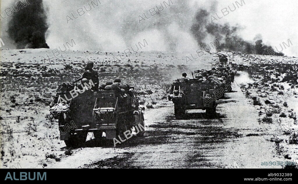 Israeli forces advance as Egyptian army tanks are destroyed in action in the Sinai Peninsula during the Six Day War 1967.