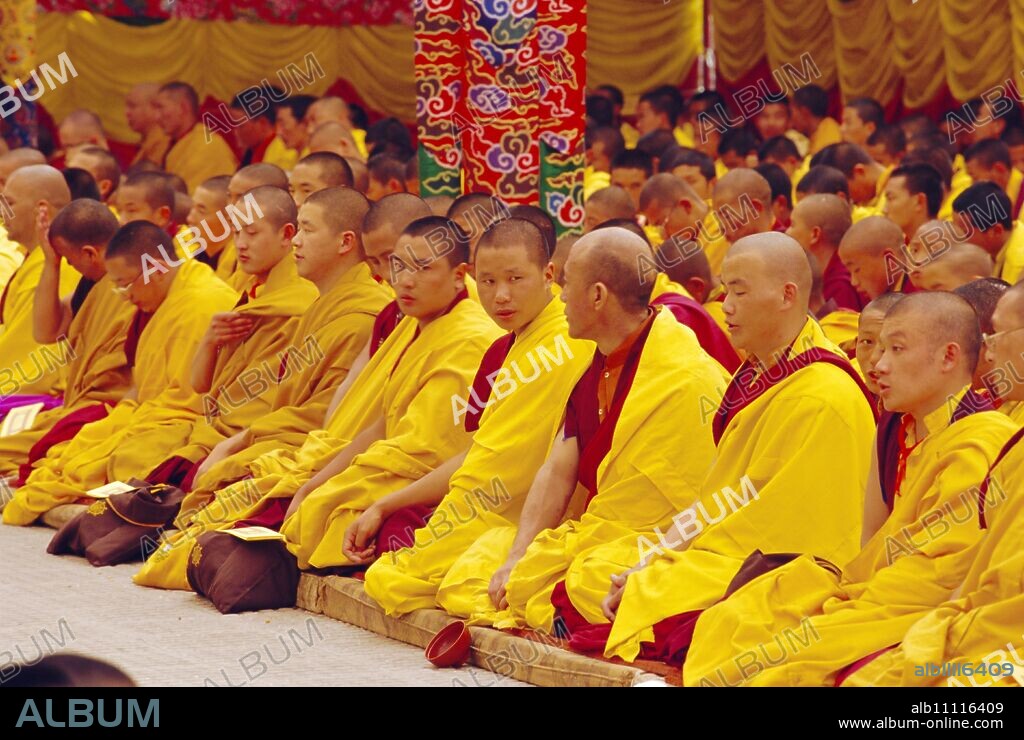 Monks sitting together inside Kargyupa gompa (monastery), Bodhnath, Katmandu, Nepal.
