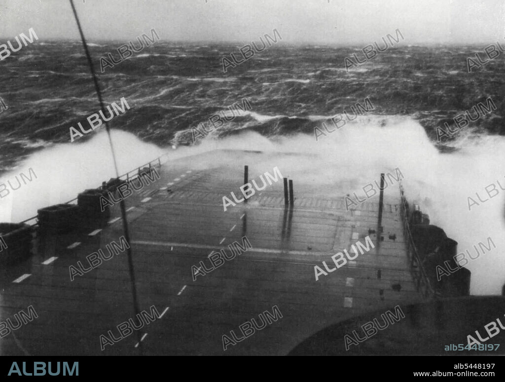 Enterprise Has Rough Crossing - The aircraft carrier enterprise is lashed by heavy seas on Dec.21, during her voyage from Europe to the U.S. with 5,057 service personnel. The vessel passed through four consecutive storms in the nine-day voyage and fought towering waves. He docked in Staten island, N.Y.C., December 24. December 24, 1945. (Photo by Associated Press Photo).