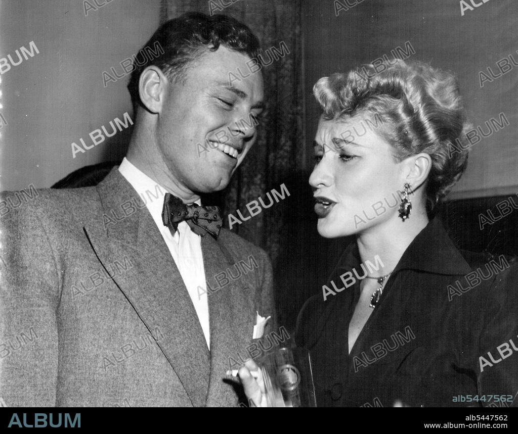 Attractive actress, Nonnie Piper who was a guest at His Excellency and Begum Haroon's cocktail party, looks worried at something that amuses David Whitford. January 11, 1951.