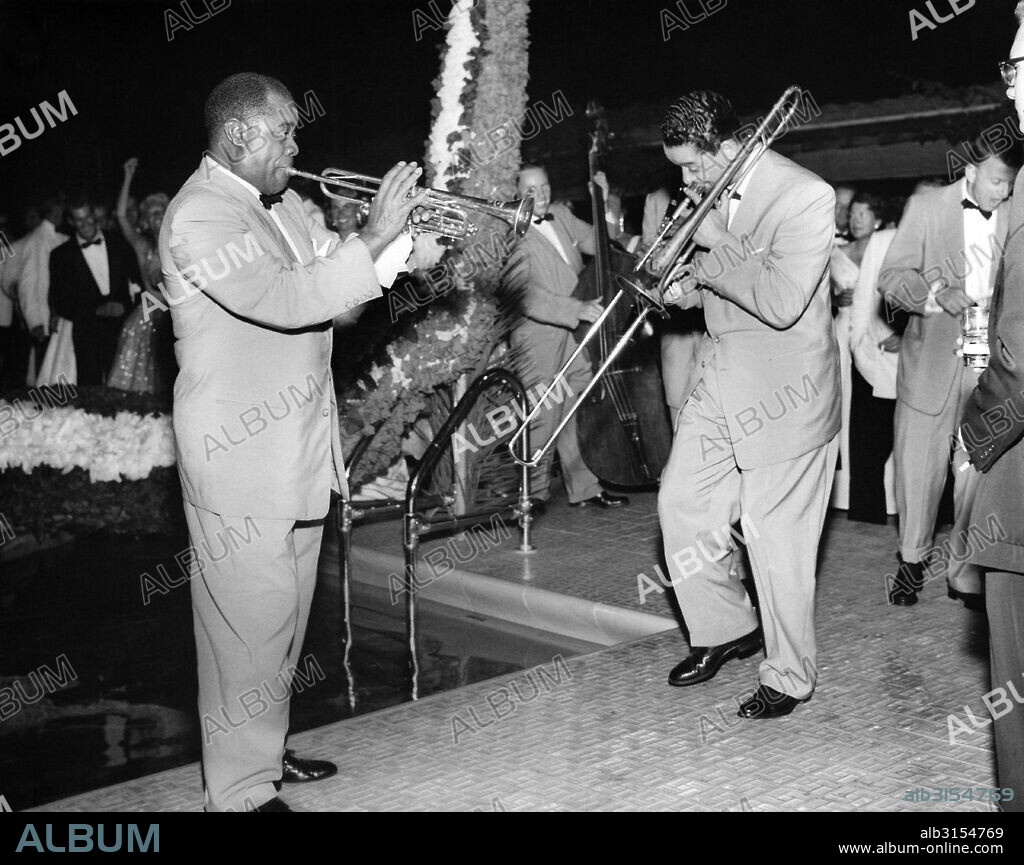 United States:  c.  1948 Trumpeter Louis Armstrong and his band playing by a pool at a party.