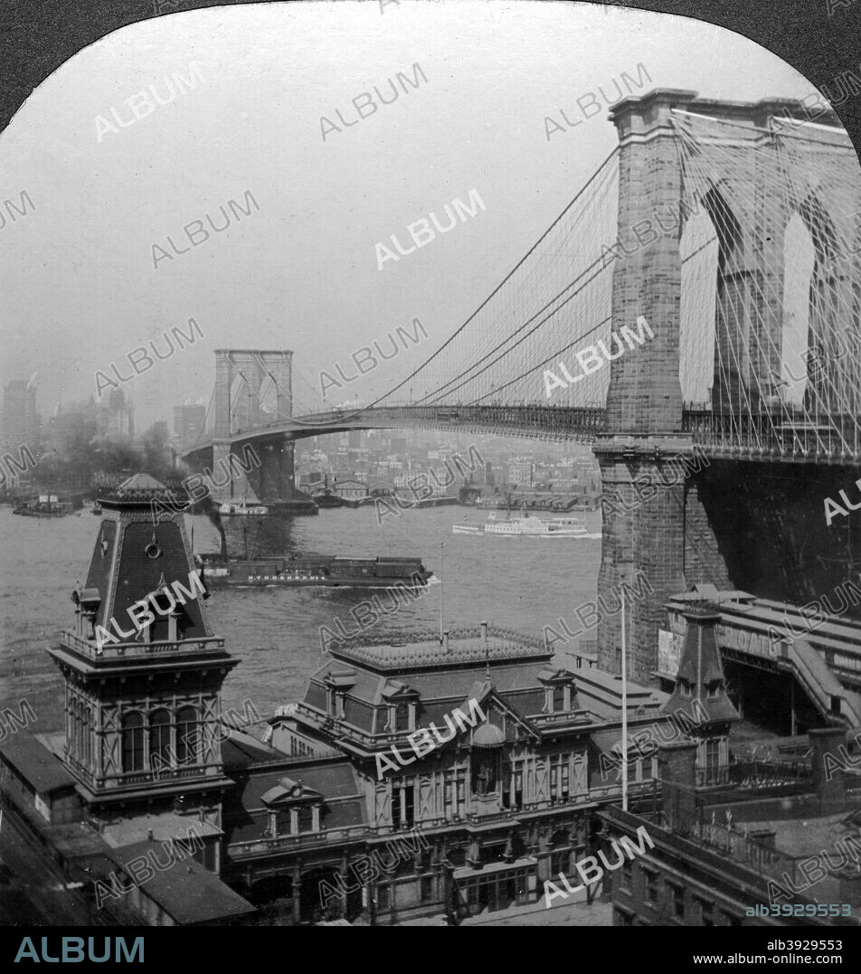 Brooklyn Bridge, New York, USA. Designed by John Augustus Roebling, the Brooklyn Bridge (foreground) over the East River was heralded as one of the most important construction projects of the 19th century. When completed it was the longest suspension bridge in the world. Roebling died of tetanus in 1869 after his foot was crushed in an accident during construction. His son, Washington, took over as chief engineer, and saw the project to its successful conclusion with the assistance of his wife Emily after Washington himself was incapacitated by an attack of the bends suffered while working below the river bed. Stereoscopic card detail.