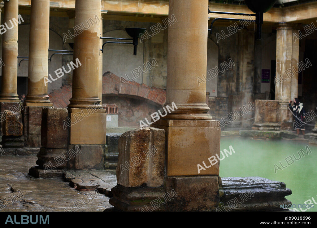 Roman baths at Bath, England. The Roman Baths complex is a site of historical interest in the English city of Bath. the Roman Bath House is supplied by water which bubbles up from the ground at Bath and fell as rain on the nearby Mendip Hills. The temple was constructed in 60-70 AD and the bathing complex was gradually built up over the next 300 years. During the Roman occupation of Britain, and possibly on the instructions of Emperor Claudius, engineers drove oak piles to provide a stable foundation into the mud and surrounded the spring with an irregular stone chamber lined with lead.