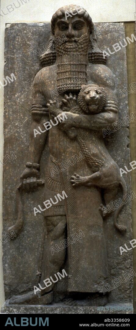 ASSYRIAN ART. Hero Gilgamesh mastering a lion.