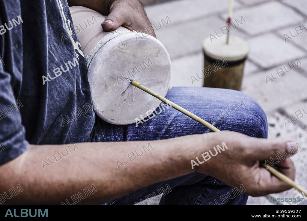 playing Ximbomba 'rumble-pot', Llucmajor, Migjorn, Mallorca, Balearic Islands, Spain.