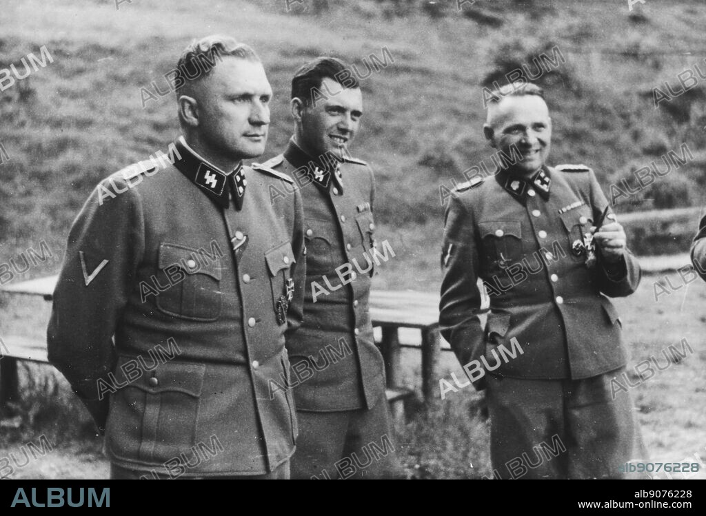 Auschwitz, Poland. Three SS officers socialize on the grounds of the SS retreat outside of Auschwitz, at "Solahutte", 1944. From left to right they are: Richard Baer (Commandant of Auschwitz), Dr. Josef Mengele and Rudolf Hoess (the former Auschwitz Commandant).