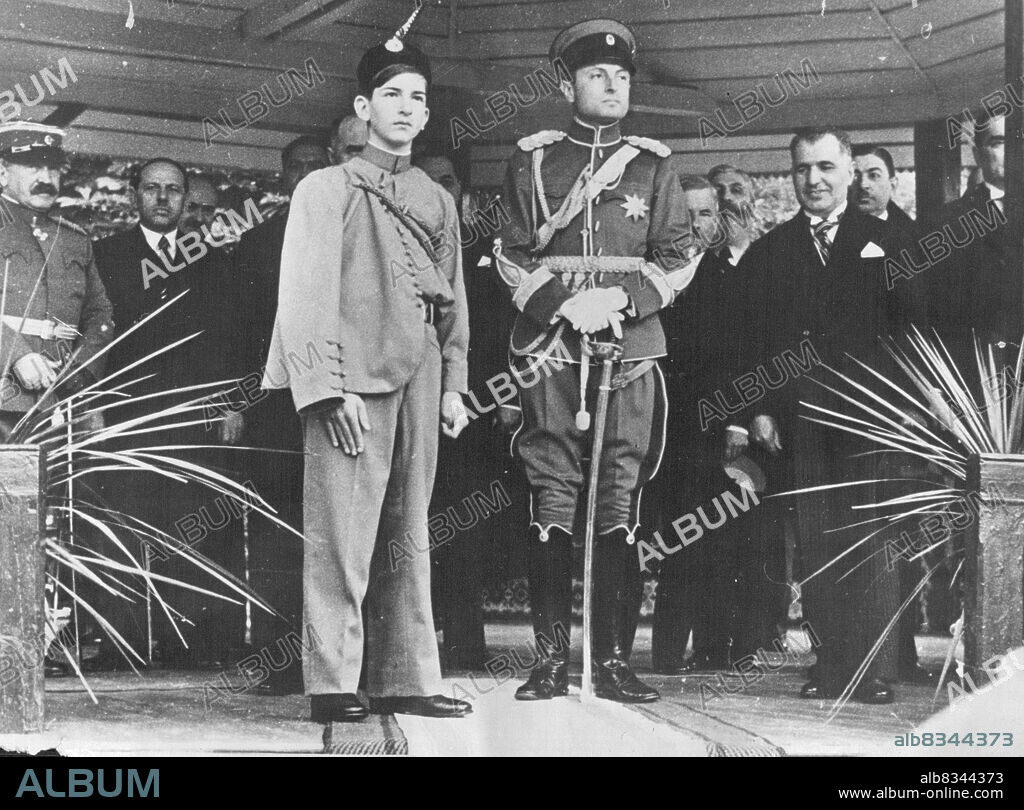 Boy Monarch takes Salute.King Peter II - The boy King of Yugoslavia made his forst public appearance since he Ascend the throne on October 1934.He attended the "Slava" of the household Cavalry Brigade. King Peter has accompanied by the ***** recent, Prince Paul, and wore the uniform of a Sokol a member of the Yugoslavia national Gymnastic Association.H.M. King Peter II, H.RH. The Prince Regent Paul, Dr. Perovitch, and the Premier, Dr. St. Jadinovitch, on the tribune.  May 27, 1936. (Photo by Sport and General Press Agency Limited).