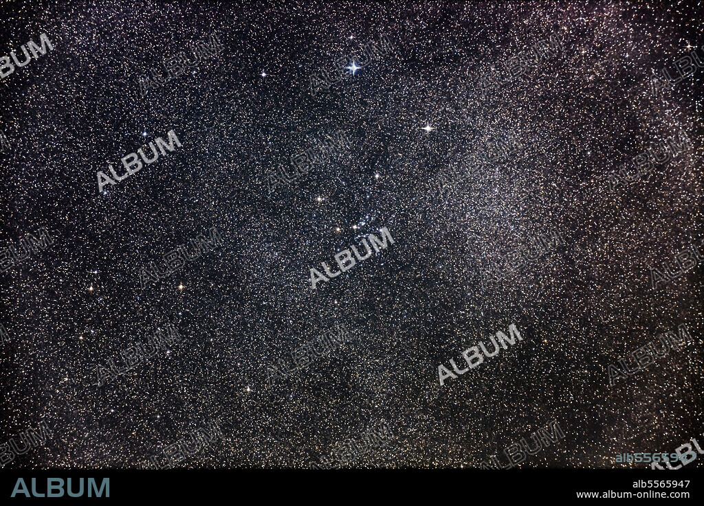 Messier 25, a bright star cluster in Sagittarius, with the object low in the south.
