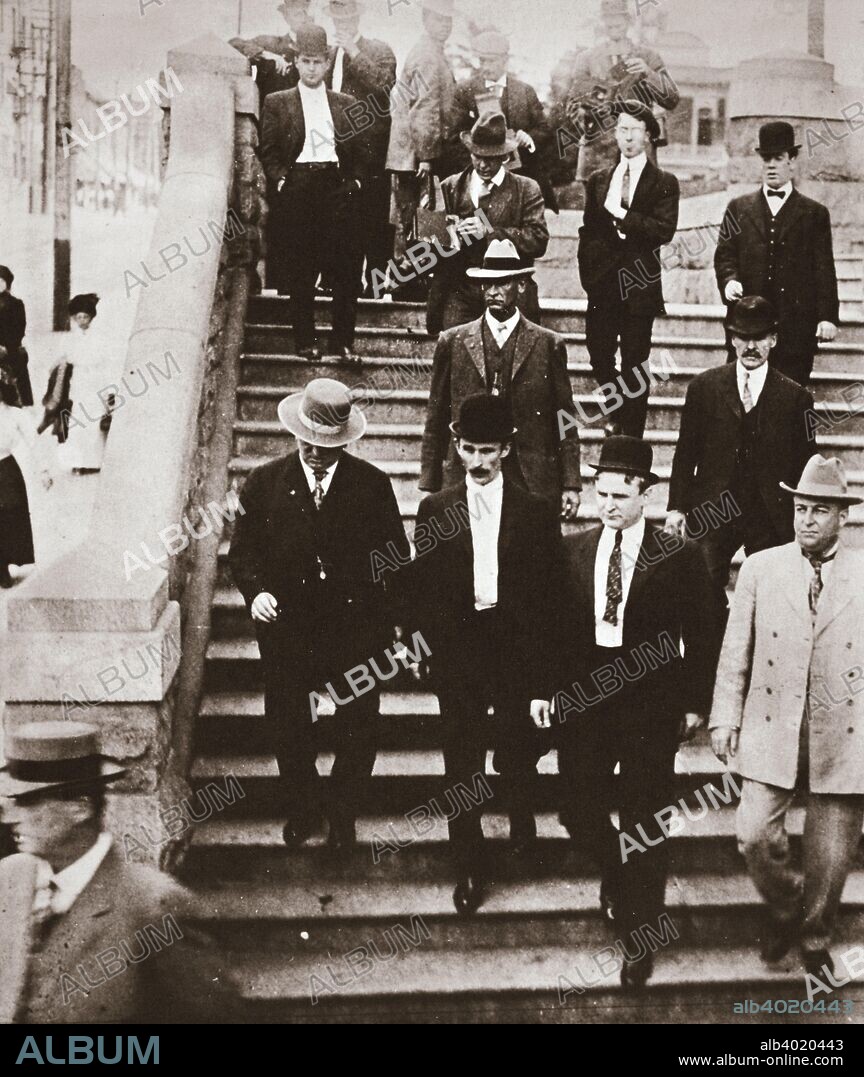 The McNamara brothers on their way back to jail, California, USA, 1911. John and James McNamara were Los Angeles trade unionists who bombed the offices of the 'Los Angeles Times' in 1910 during a labour dispute, causing a fire that killed 21 workers and injured a further 100. They were represented at their trial by the celebrated lawyer Clarence Darrow. Darrow realised that evidence proved that the brothers were guilty and convinced them to withdraw their original not guilty pleas and plead guilty instead. James McNamara was sentenced to life imprisonment, dying in prison in 1941, while John served 15 years. Although Darrow had succeeded in avoiding the death penalty for his clients, he was widely perceived within the union movement as having sold them out. In addition, evidence came to light of attempts, in which Darrow was implicated, to bribe members of the jury, for which he faced two lengthy trials. He was acquitted in the first case, but the second trial resulted in a hung jury. The District Attorney agreed not to proceed with a retrial on the proviso that Darrow promised not to practice law in California again.