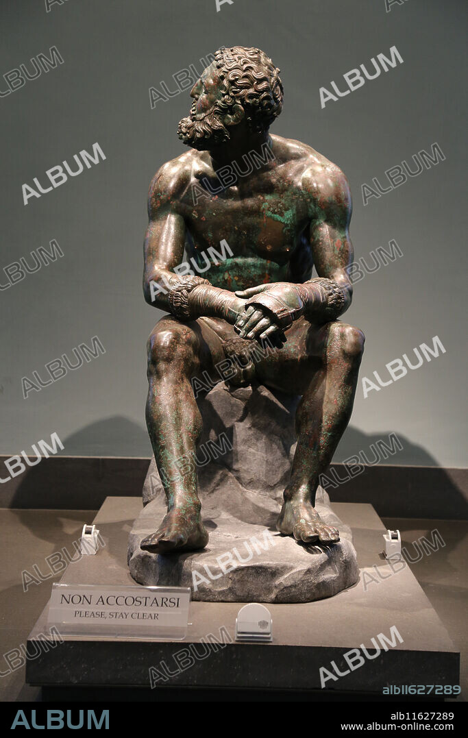 Boxer at Rest. Hellenistic Greek Sculpture. C. 330 BC. Sitting nude boxer at rest, still wearing caestus. National Museum of Rome. Massimo Palace. Italy. Rome.