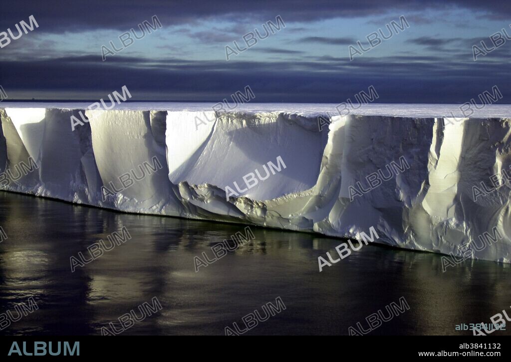 Northern edge of the giant iceberg B-15A, located close to Ross Island, Antarctica. Iceberg B-15A is a fragment of a larger iceberg (B-15) that broke away from the Ross Ice Shelf in March 2000. Researchers have placed GPS, weather monitoring stations and four seismometers on different icebergs to track them. The goal is to learn more about what causes icebergs to calve, how and why they drift, what happens when the icebergs warm, and why they are producing previously unknown tremors that are picked up on seismometers as far away as Tahiti. In 2005 prevailing currents took B-15A past the Drygalski ice tongue; the collision broke off the tip of Drygalski in mid-April. Iceberg B-15A sailed on along the coast leaving McMurdo Sound until it ran aground off Cape Adare in Victoria Land, where it broke into several smaller pieces on Oct. 27/28, 2005. The largest piece is still named B-15A , additional pieces were named B-15P, B-15M and B-15N. It has since moved farther up north and broken up into more pieces.