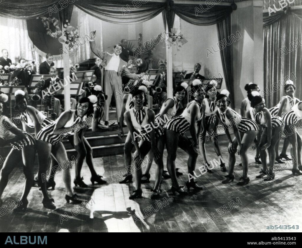 Calloway with his band and dancers onstage at the Cotton Club, NYC. Cab Calloway (1907 - 1994) was an African-American jazz singer, dancer, bandleader and actor. Calloway was a master of scat singing and led one of the most popular big bands from the 1930s-40s. By mixing jazz and vaudeville he won popular acclaim during a career that spanned over 65 years. No photographer credited, 1937 (cropped and cleaned).