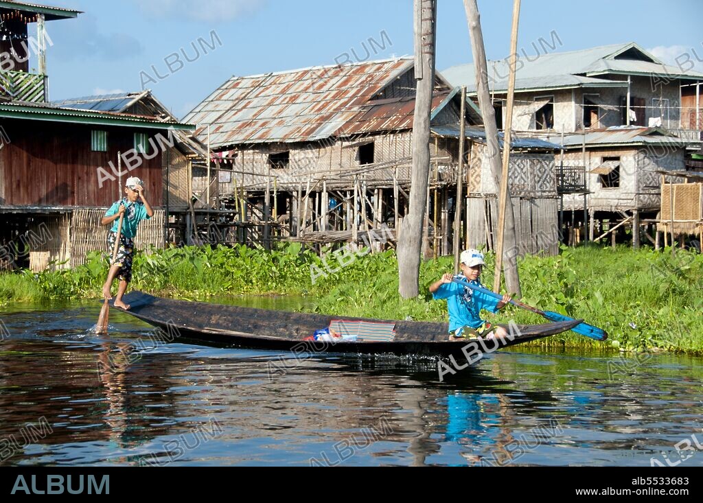 Inle Lake is a freshwater lake located in the Nyaungshwe Township of Taunggyi District of Shan State, part of Shan Hills in Myanmar (Burma). It is the second largest lake in Myanmar with an estimated surface area of 44.9 square miles (116 km2), and one of the highest at an altitude of 2,900 feet (880 m). The people of Inle Lake (called Intha), some 70,000 of them, live in four cities bordering the lake, in numerous small villages along the lake's shores, and on the lake itself. The entire lake area is in Nyaung Shwe township. The population consists predominantly of Intha, with a mix of other Shan, Taungyo, Pa-O (Taungthu), Danu, Kayah, Danaw and Bamar ethnicities. Most are devout Buddhists, and live in simple houses of wood and woven bamboo on stilts; they are largely self-sufficient farmers. Most transportation on the lake is traditionally by small boats, or by somewhat larger boats fitted with single cylinder inboard diesel engines. Local fishermen are known for practicing a distinctive rowing style which involves standing at the stern on one leg and wrapping the other leg around the oar. This unique style evolved for the reason that the lake is covered by reeds and floating plants making it difficult to see above them while sitting. Standing provides the rower with a view beyond the reeds. However, the leg rowing style is only practiced by the men. Women row in the customary style, using the oar with their hands, sitting cross legged at the stern. The Inle lake area is renowned for its weaving industry. The Shan-bags, used daily by many Burmese as a tote-bag, are produced in large quantities here. Silk-weaving is another very important industry, producing high-quality hand-woven silk fabrics of distinctive design called Inle longyi. A unique fabric from the lotus plant fibers is produced only at Inle lake and is used for weaving special robes for Buddha images called kya thingahn or 'lotus robe'.