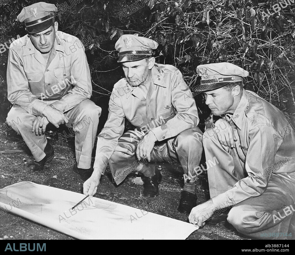 Commander of the U.S. Army in the South Pacific area pointing to his map as two members of his staff look on, New Caledonia, circa 1942.